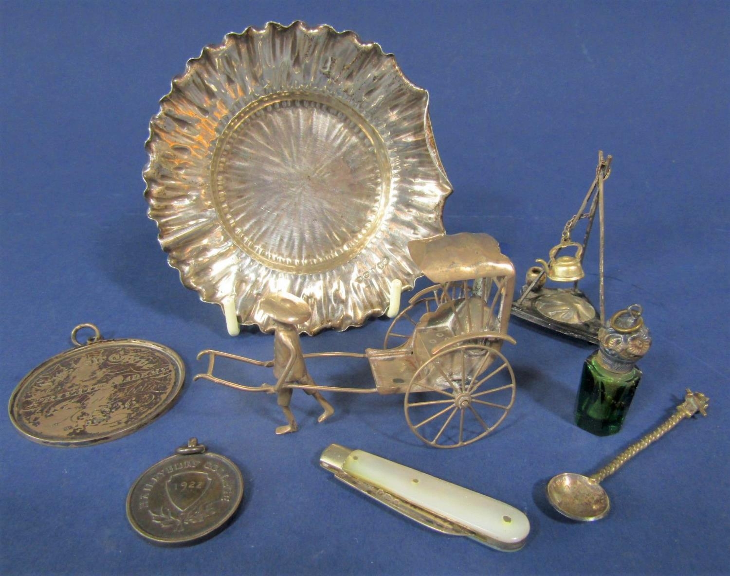 An interesting collection of silver items to comprising an Eastern white metal character group of