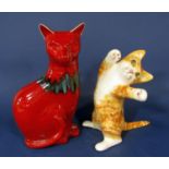 A Winstanley model of a playful ginger and white cat in upright stretching position with yellow eyes