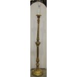 Carved and gilded lamp standard, fluted column raised on a disc base