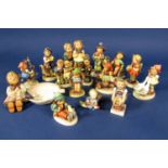 A collection of Hummel figures including an ashtray with applied figure of a child knitting, etc, (