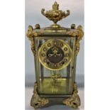 French brass and ormolu four glass mantel clock in the rococo manner, with scrolled fittings mounted