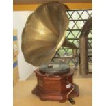A HMV table top wind up gramophone with oak octagonal base and embossed sheet brass/tin