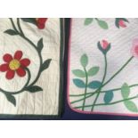 2 large quilts/ bed spreads with applique motifs and quilted with running stitch; the first with