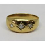 Yellow metal star cut gypsy ring, set with three white stones (one side stone a diamond), size L,