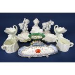 A pair of Royal Worcester sweetmeat dishes, supported by dolphins, with green printed marks to base,
