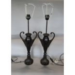 A pair of lacquered bronzed twin handled baluster vase lamps, upon darted leaf plateau bases, 60cm