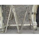 A pair of substantial vintage A framed folding trestles, 220cm high, together with three further