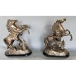a pair of cast spelter figures of Marley horses, upon oval ebonised plinth bases, 44cm high (2)