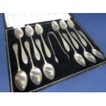 Cased suite of twelve Irish silver bright cut teaspoons with a pair of sugar nips, maker Hopkins &