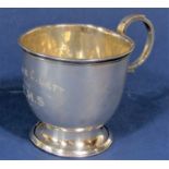 Early 20th century oversized silver cup with C scroll handle and stepped circular base, inscribed,