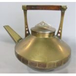 Arts & crafts brass kettle/teapot, with stylised handle and pediment with pierced graduated circle
