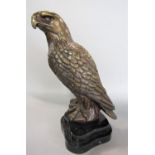 A bronze study of a standing eagle upon a black plinth marble base, 28 cm high