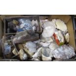 A box containing a collection of antique rock formations to include calcium, quartz and other