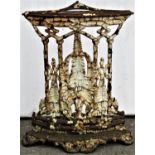 A weathered Victorian cast iron fern pattern corner umbrella/stick stand with four oval divisions