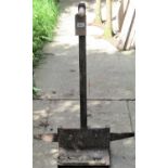 A boot scraper with square tubular shaft and platform base, with worn brushes, labelled Attissons (