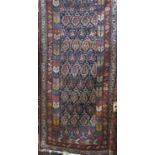 A good quality Persian runner with geometric paisley decoration upon a blue ground, 350 x 105 cm