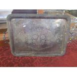 A large silver plated twin handled gallery tray, centrally decorated with a floral bouquet, framed