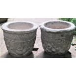 A pair of small reclaimed garden planters of circular form with repeating lions mask, foliate and