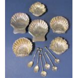 Two pairs of cast scallop shell silver salts upon three ball feet, together with a collection of