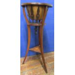 An inlaid Edwardian mahogany torchere jardinere stand raised on three swept supports with