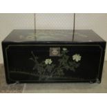 a black lacquered Chinese blanket chest with painted detail