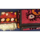 2 eastern style textile panels with bold colours and embroidered motifs using couch stitch; one