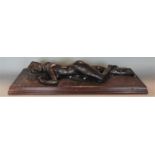 Bronzed spelter figure of a reclining nude female upon a wooden plinth base, 61 cm long (AF)