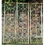 A run of three decorative iron work panels with ring scrollwork detail, each panel 186 cm high (full