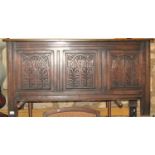 An Old English style oak coffer, the front elevation enclosed by three panels with repeating