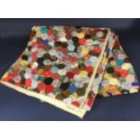 Large traditional patchwork quilt comprised of multi-coloured hexagons with piped edge, dated