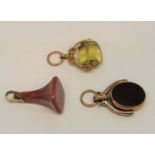 Three antique yellow metal fobs to include a 10ct swivel fob set with bloodstone / carnelian (3)
