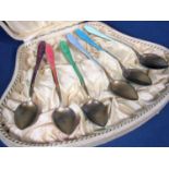 A cased set of continental gilt silver and enamelled coffee spoons, within a fitted case inscribed