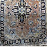 A Persian rug with central blue floral medallion upon an orange ground, 190 x 120 cm