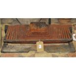 An unusual low artisan design cast iron fire basket of rectangular form with graduated bars,