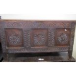 18th century oak coffer, the front elevation with sunburst and foliate detail, set beneath a plank