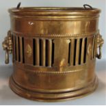 A good antique brass coal of log bin with good lions head ring handles and geometric pierced and