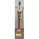 A brass table lamp with Corinthian column set on a square cut base