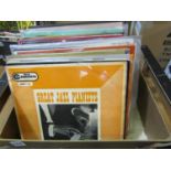 A collection of vinyl jazz LPs, artists include Charlie Parker, Louis Armstrong, Fats Waller, Duke