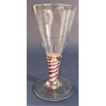A good quality antique tapered cordial glass with coloured latticino stem work and rough pontil