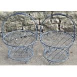 A pair of contemporary decorative galvanised wirework baskets with fixed loop handles, lattice and