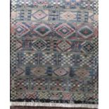 Unusual full pile tribal type rug with various medallions upon a washed blue ground, 190 x 120 cm