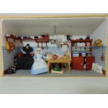 Diorama with glazed front panel (unfixed) featuring a Victorian kitchen scene with cooking range,