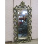 A narrow wall mirror, the rectangular plate set within a moulded frame, with scrolling acanthus