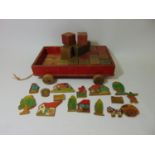 Vintage wooden tow along cart with bricks, and a collection of wooden farm animal and building