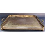 A good quality twin handled gallery tray, engraved with floral swags and scrolled acanthus on four