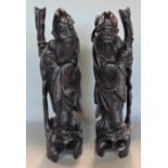 A pair of Chinese carved wooden figures of sages with silver inlay, 35cm high (2)