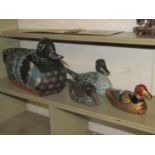 Four hand painted carved wooden model ducks of varying size, the largest 45cm long x 24cm high