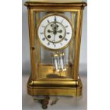 A good quality gilt brass four glass mantel clock with enamel chapter ring and open escapement, twin