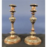 A pair of antique Sheffield plated candlesticks, with baluster acanthus columns upon stepped