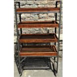 An industrial style fabricated steel four tier trolley, with removeable wooden open slatted trays,